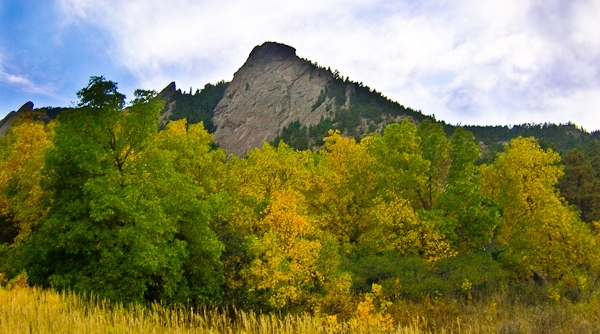 View of Boulder Flat Irons with fall color trees in foreground by RunLocal Marketing